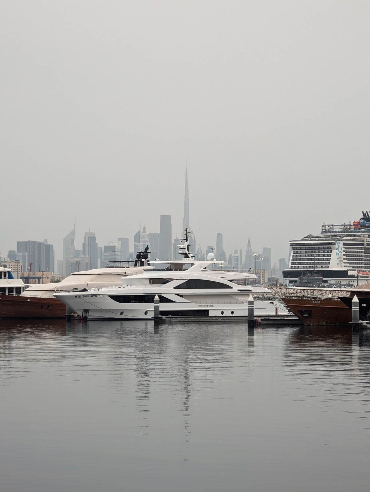 Superyacht moored in Dubai with the city skyline behind