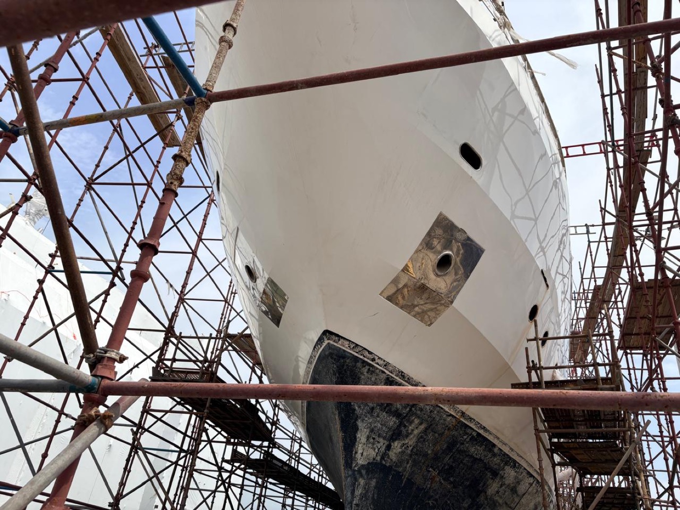 Superyacht bow in scaffolding at the shipyard